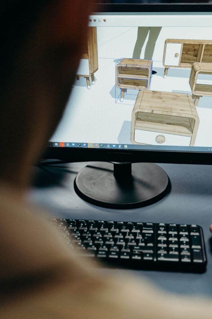 Close-up of digital furniture design on a computer monitor in an office setting.